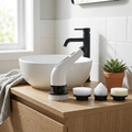 Electric spin scrubber on an oak bathroom counter with spare brush heads